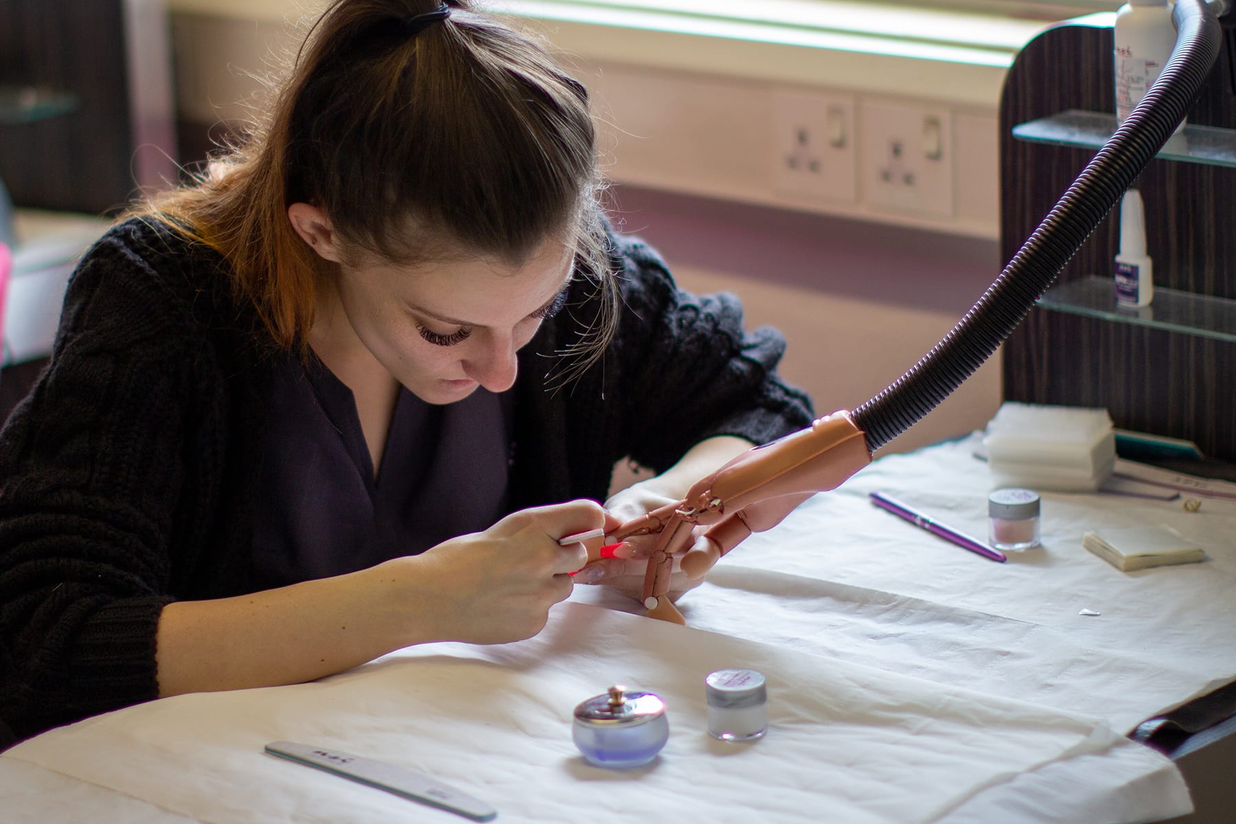 A student practices tail nechniques on a false hand.