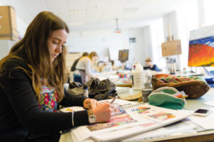 An image of a student working in their sketchbook.