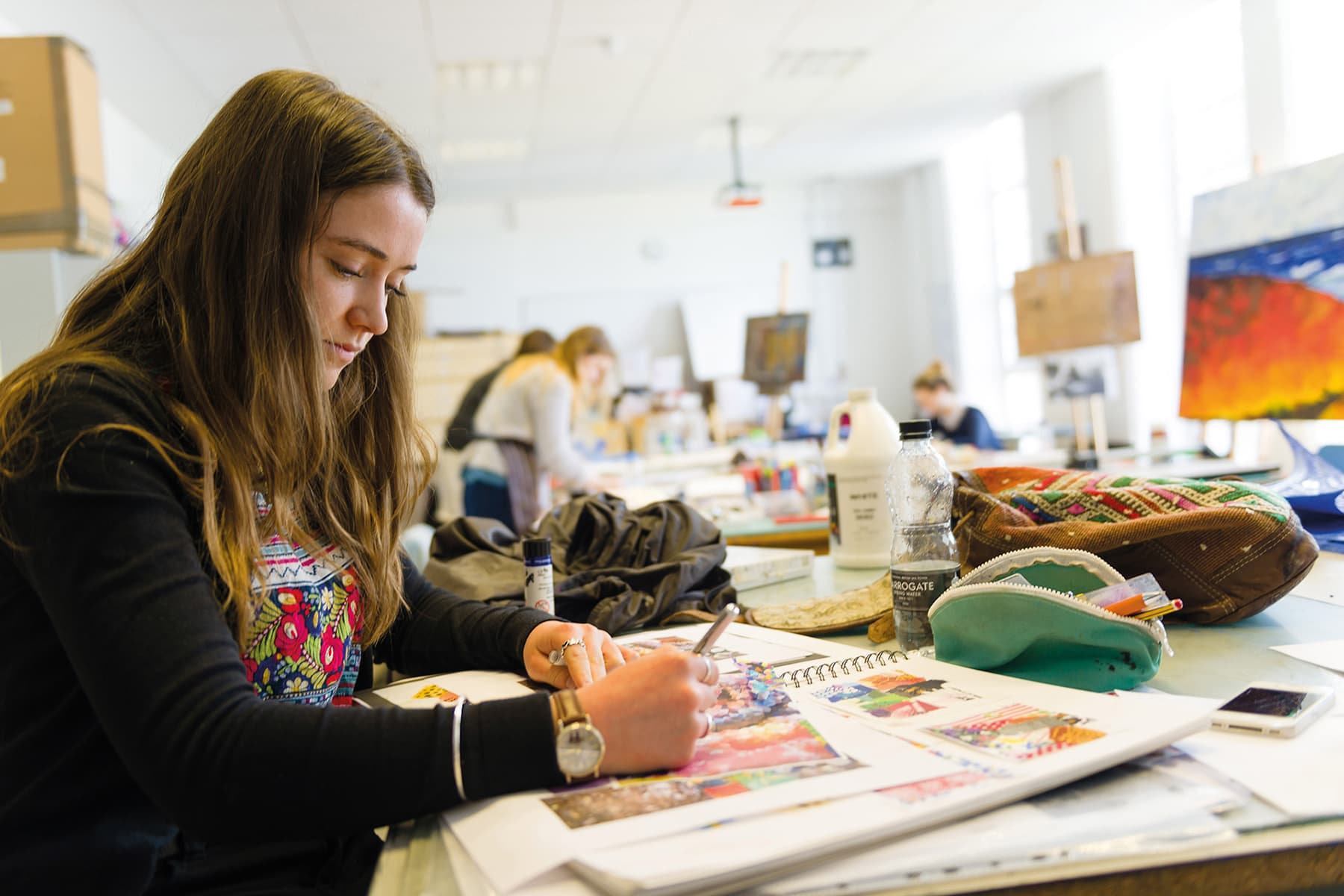 An image of a student working in their sketchbook.