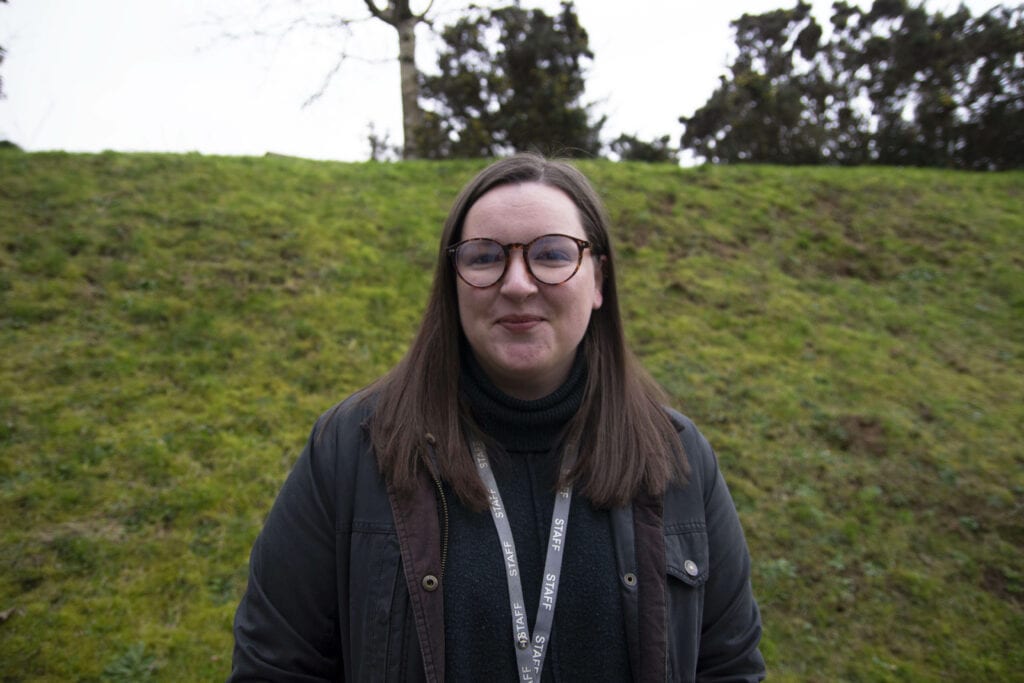 Emily stood in front of a grass bank