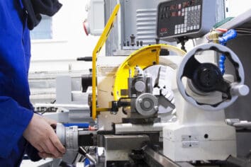 Engineering & Motor Vehicle 402 A close-up of someone working with machinery in an engineering bay.