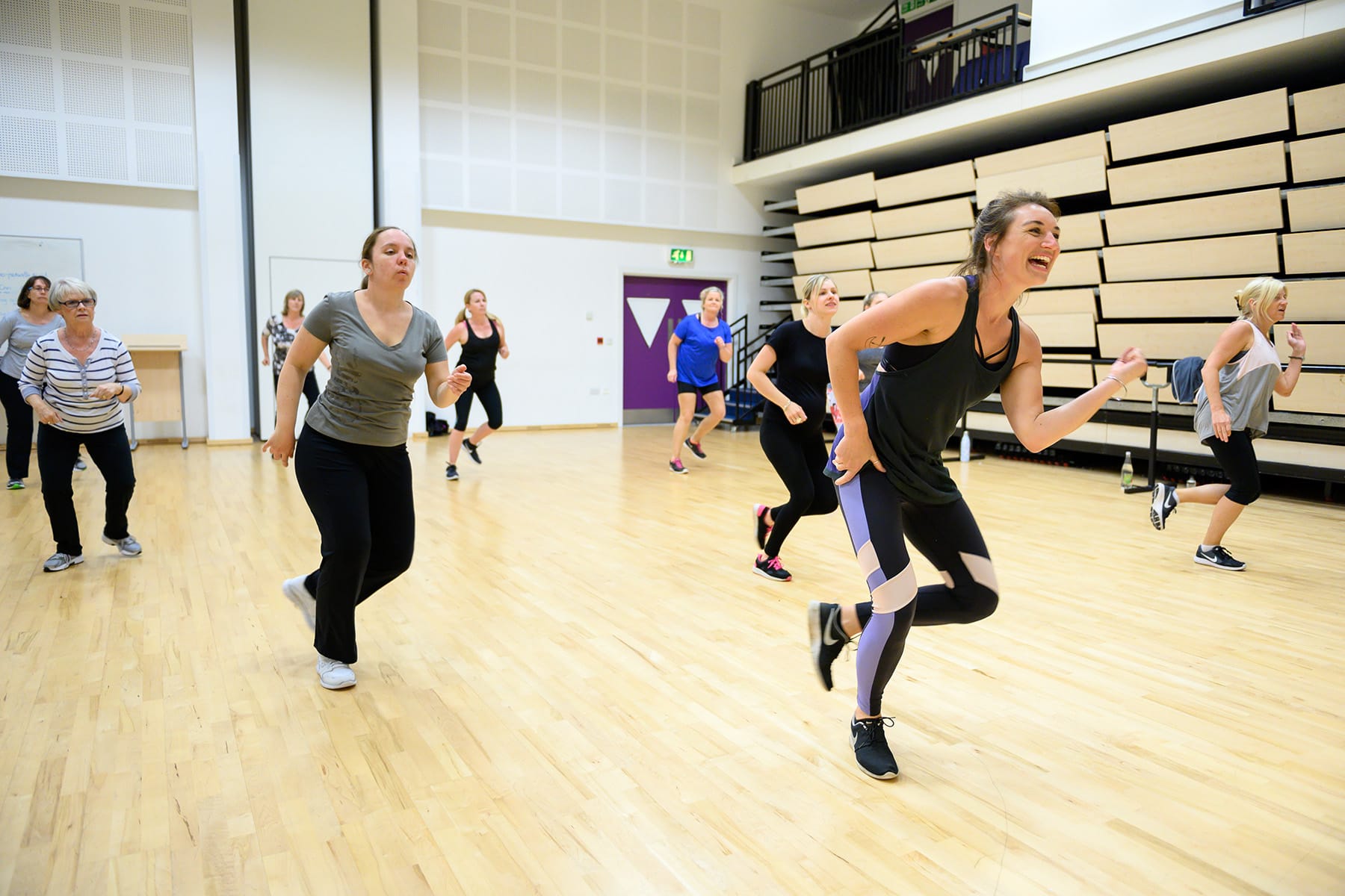 An adult dance fitness class in a College studio