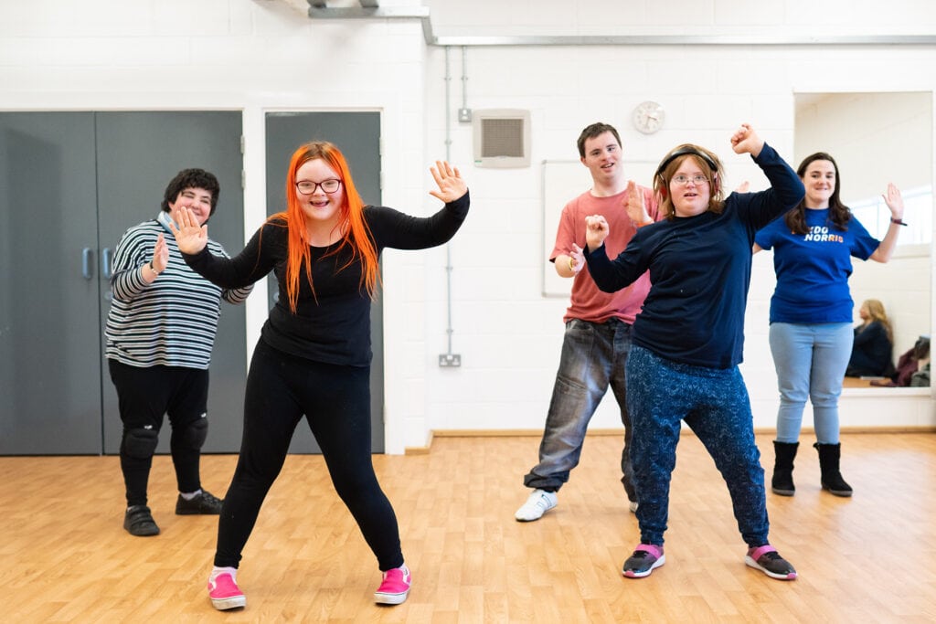 A group of students are in a dance class. They are in the middle of a performance.