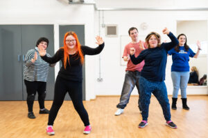 A group of students are in a dance class. They are in the middle of a performance.