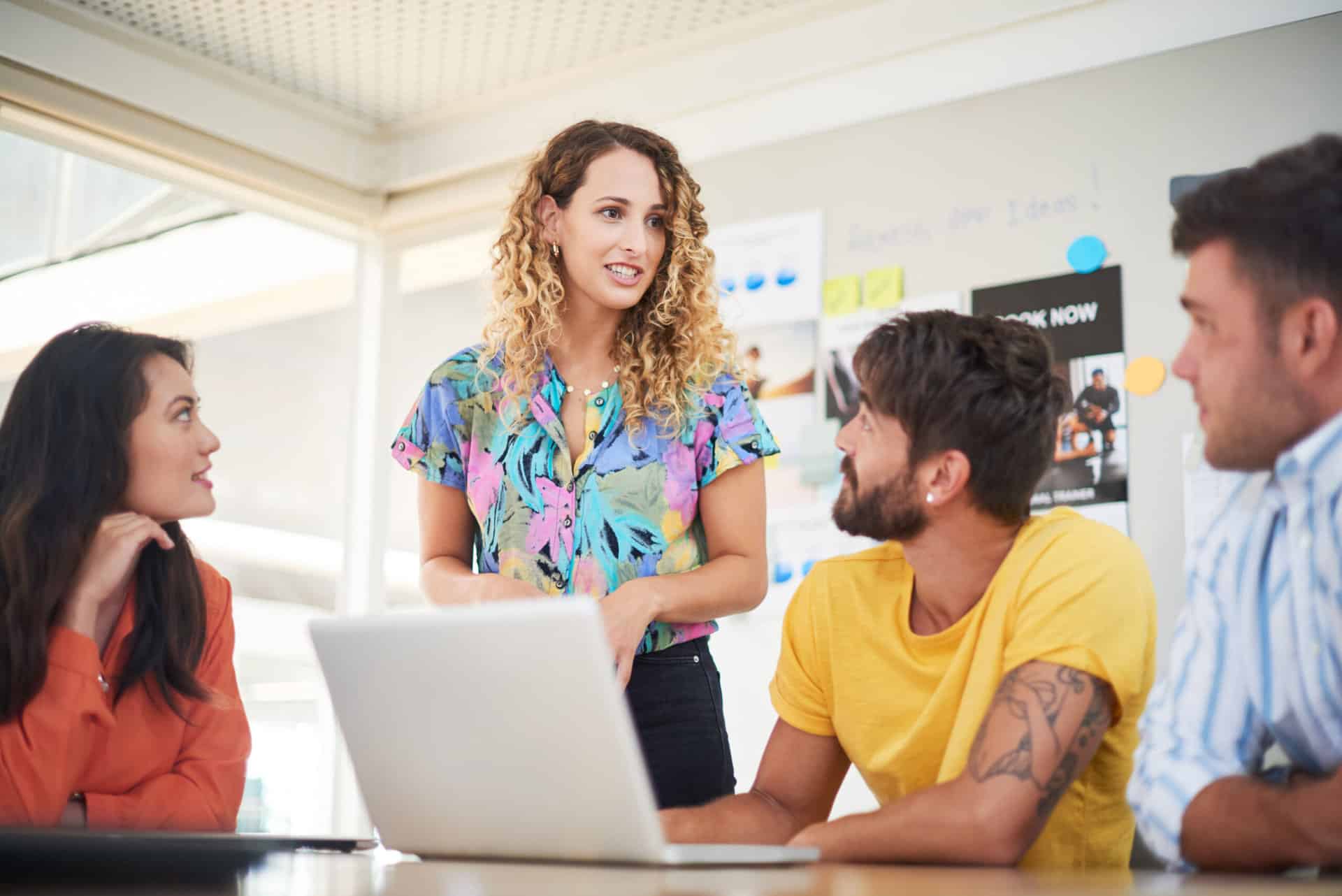 Shot of a group of young businesspeople using a laptop in a modern office