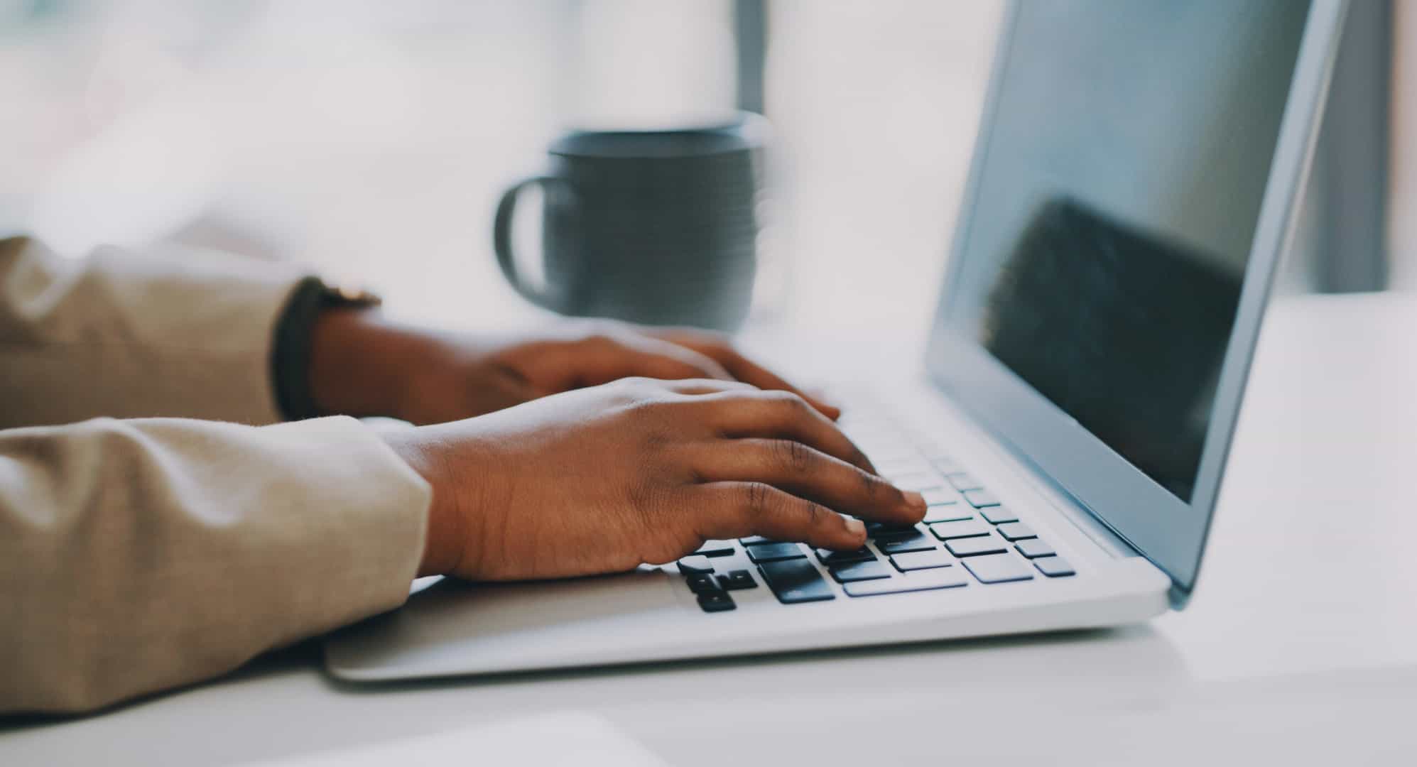 Closeup shot of an unrecognisable businesswoman using a laptop in an office