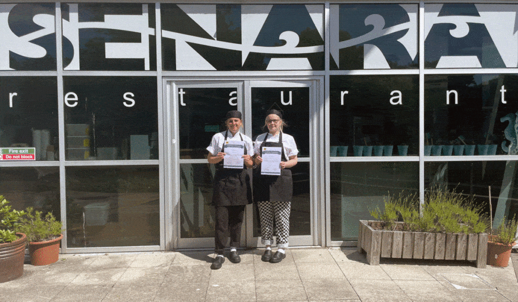 Student chefs Emily (left) and Shay (right) with their attendance certificates outside Senara Restaurant at Penwith College