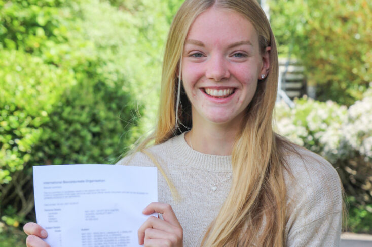 Scarlett outside holding her results