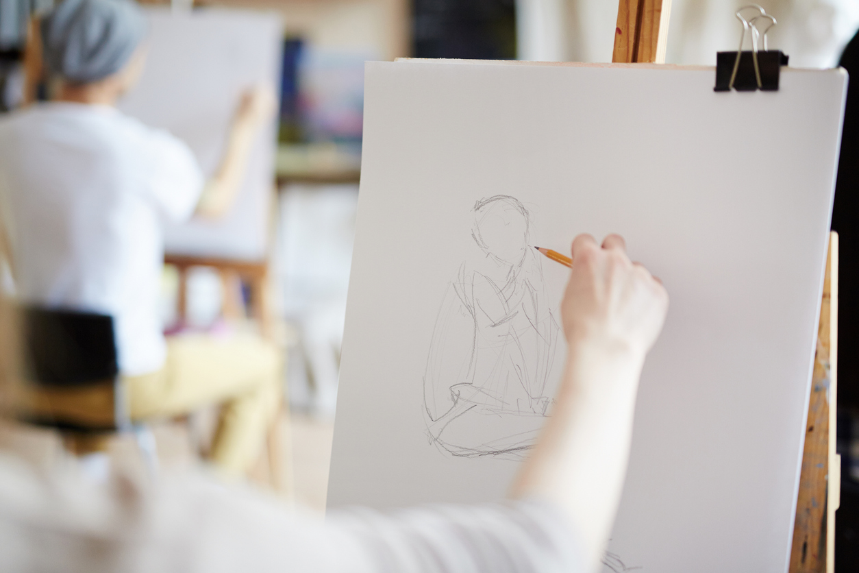 Female hand drawing portrait of a woman