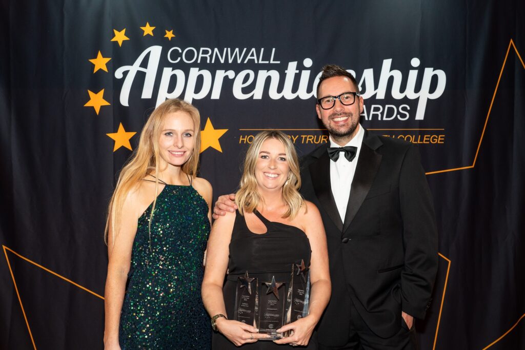 Holly Day and Neil Caddy from Pirate FM on stage with Lois - triple award winner in 2022