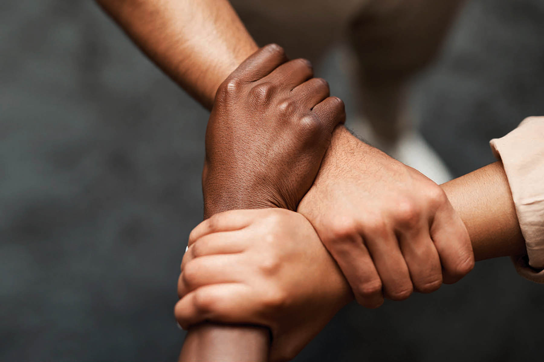 Shot Of A Group Of Businesspeople Linking Arms In Solidarity In A Modern Office Hold onto your hunger for success