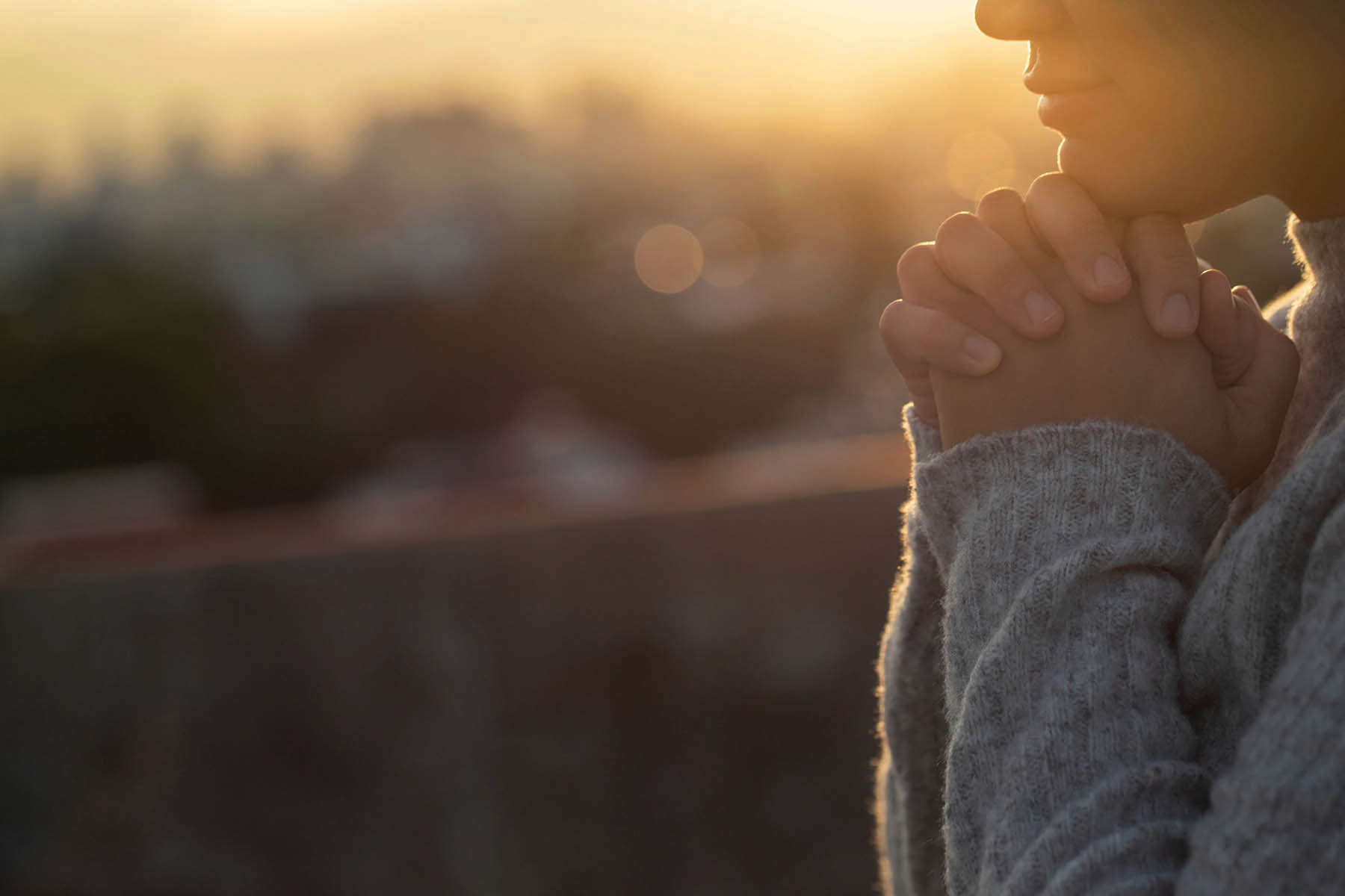 Women raise their hands to ask for blessing from God.