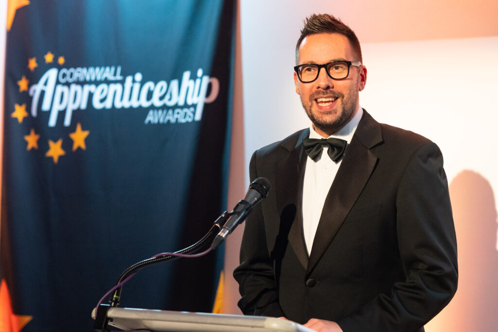 Neil Caddy from Pirate FM on stage presenting the Cornwall Apprenticeship Awards