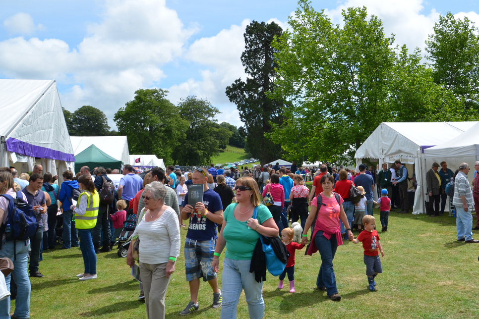 "Dorchester, UK - June 17, 2012: Crowds of people looking at stalls at the Kingston Maurward agriculture fair in Dorchester."