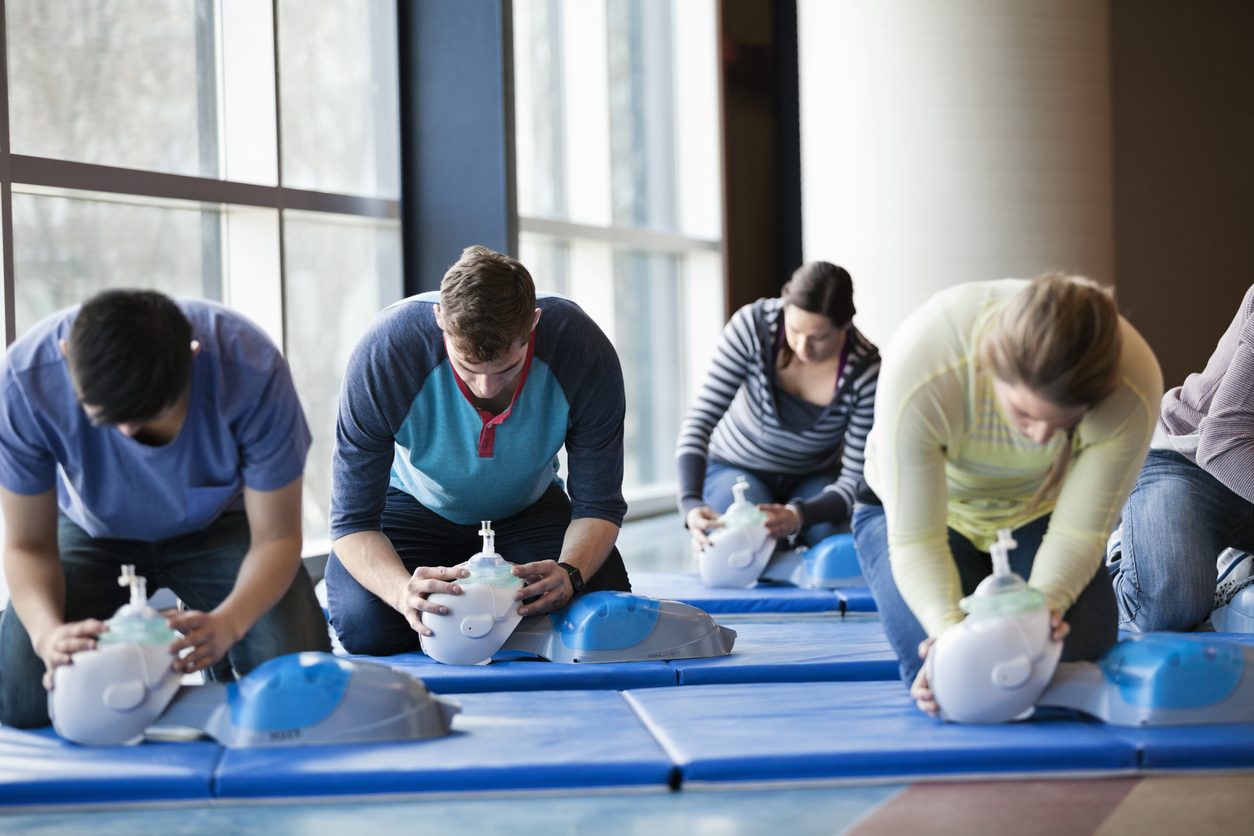 Group of people learning CPR in fitness center