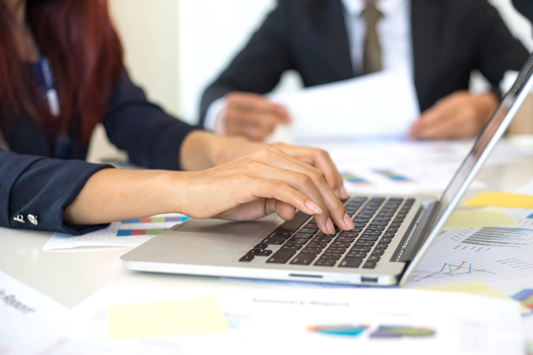 close up hand of business woman employees secretary using laptop  minutes  of executive meeting - business concept