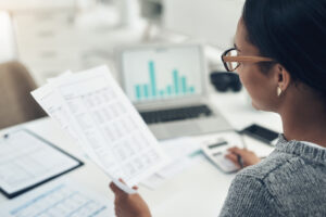 Closeup Shot Of An Unrecognisable Businesswoman Calculating Finances In An Office