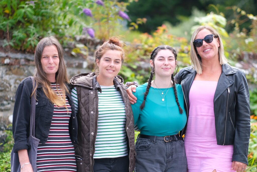 Group of four women smiling for a photo