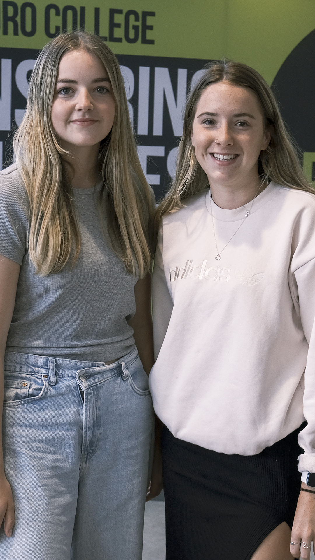 Two girls, Mia on the left and Jaz on the right, smile for a photo.