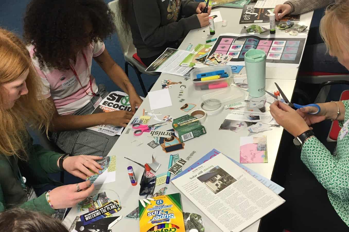 An image of students making crafts on a long table.