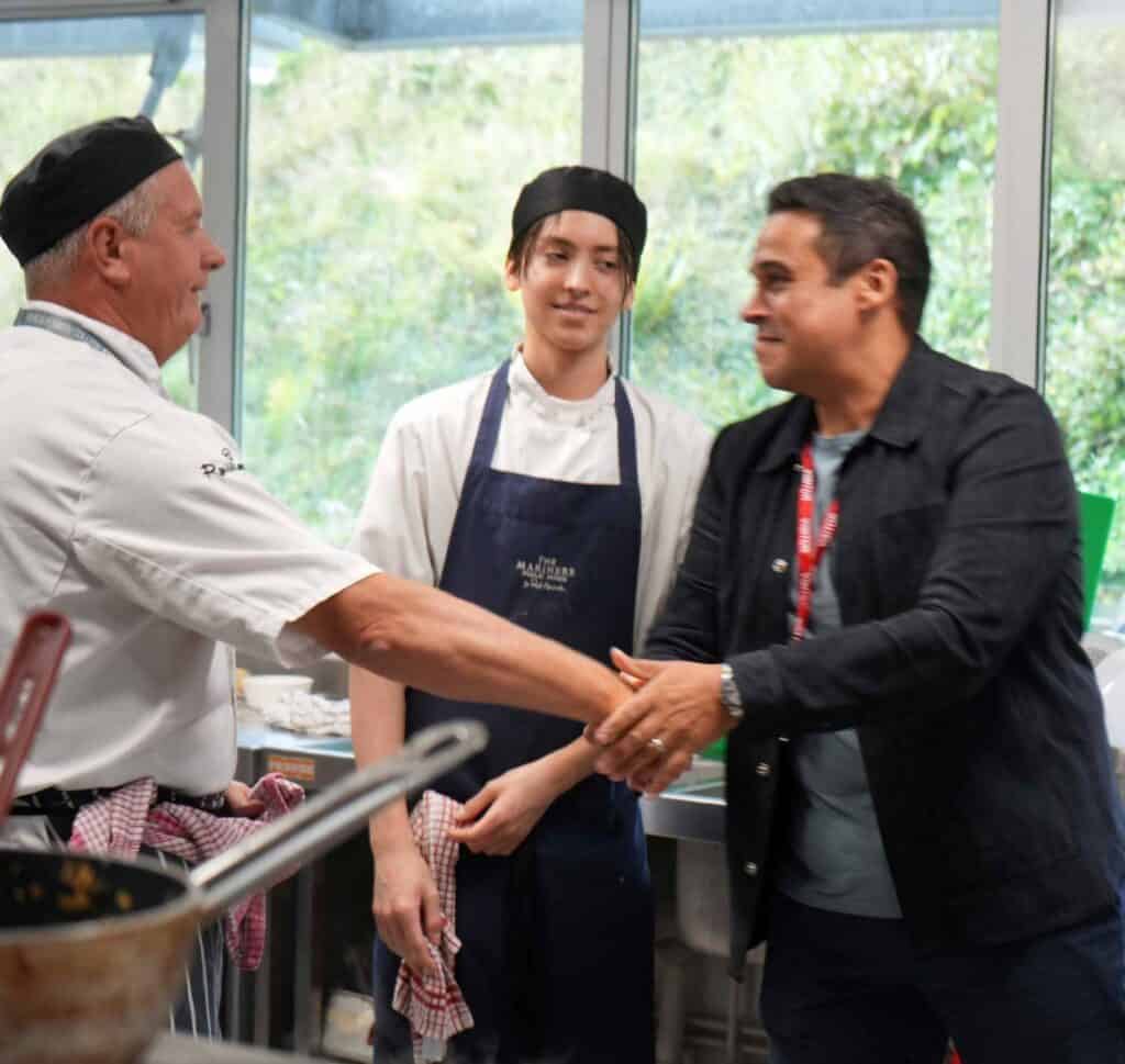 Paul Ainsworth shakes hands with professional cookery lecturer Andy