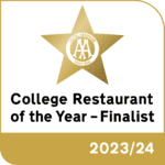 An award badge. The text reads 'College Restaurant of the Year - Finalist, 2023/24'. There is a gold star with text inside which reads 'Hotel Services, since 1908'.