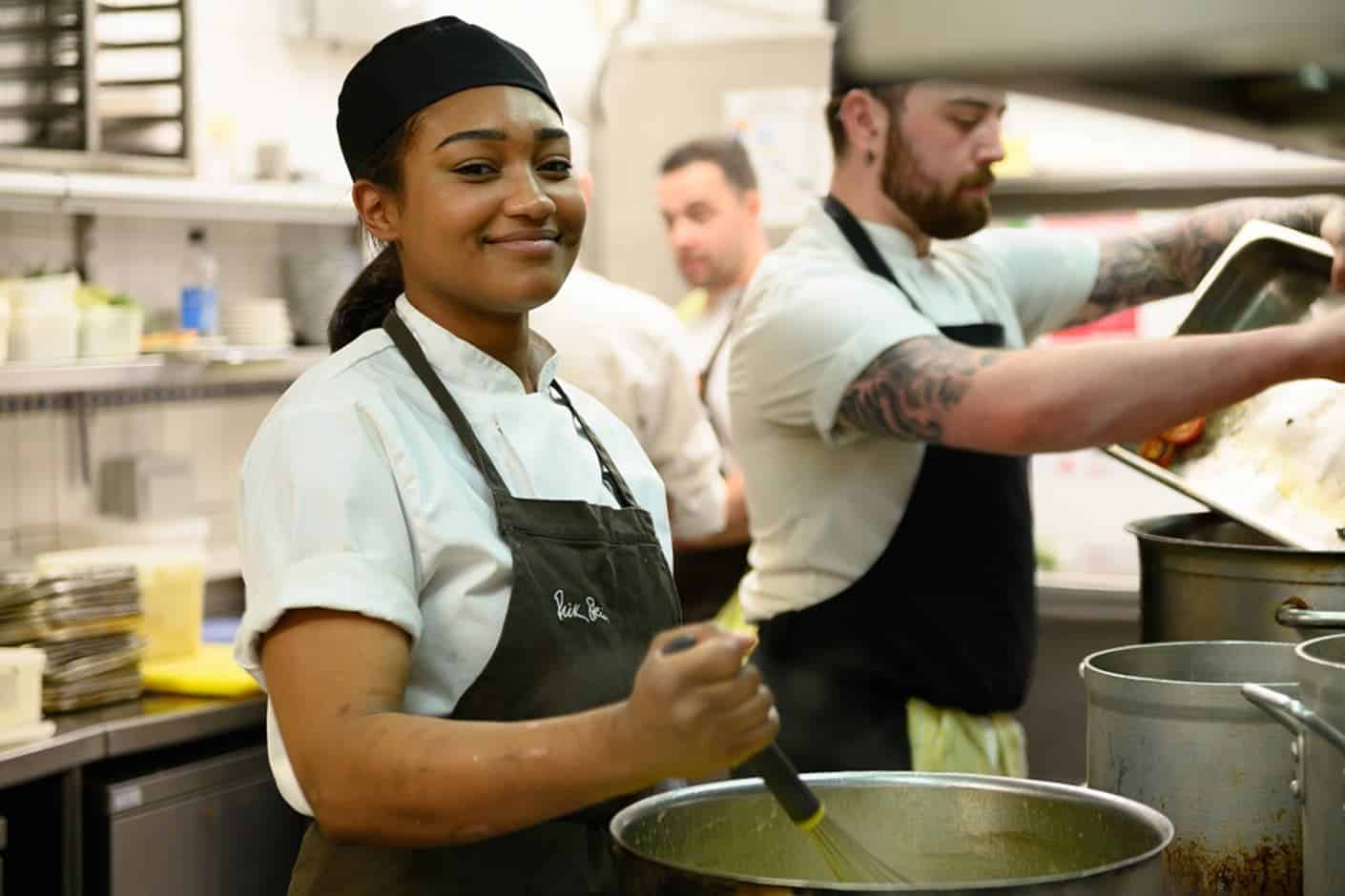 A Hospitality Apprentice working in a professional kitchen