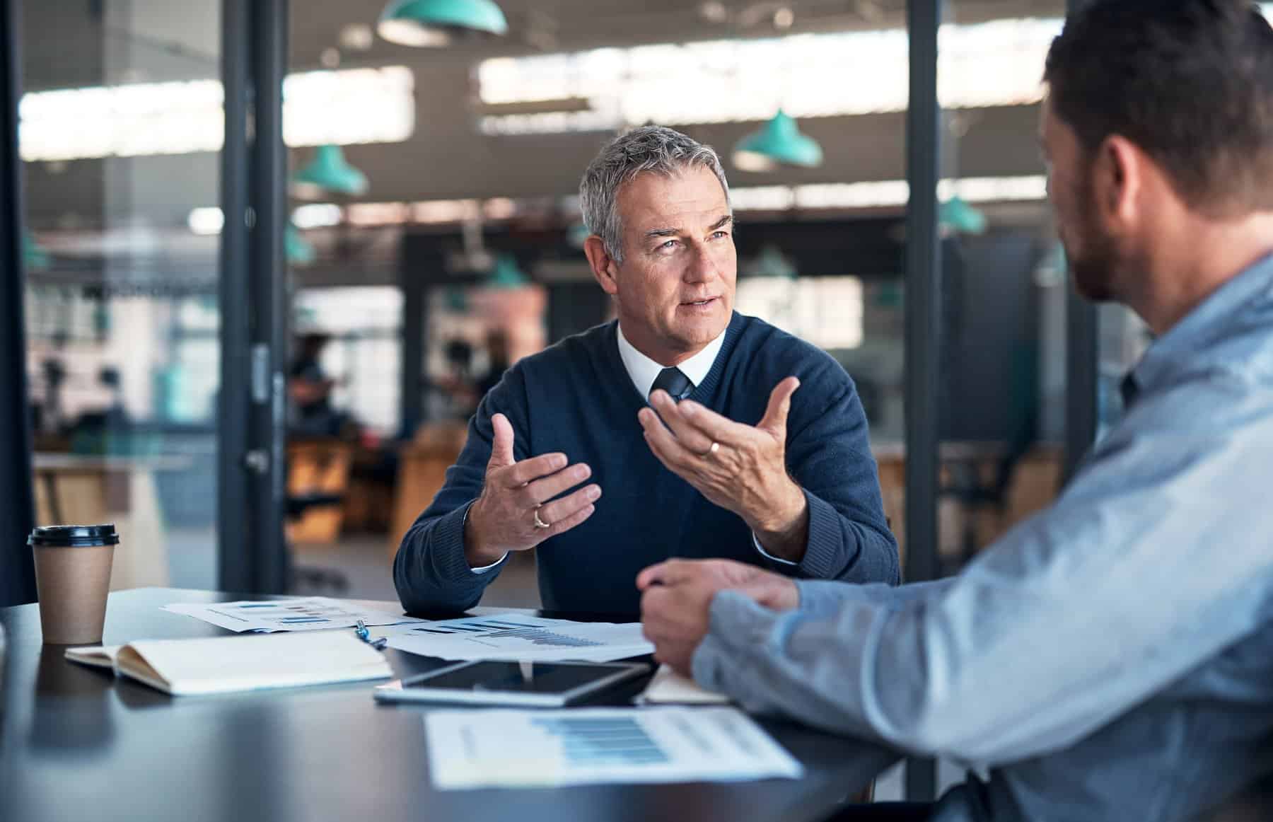 Shot of a mature businessman having a discussion with a colleague in an office.