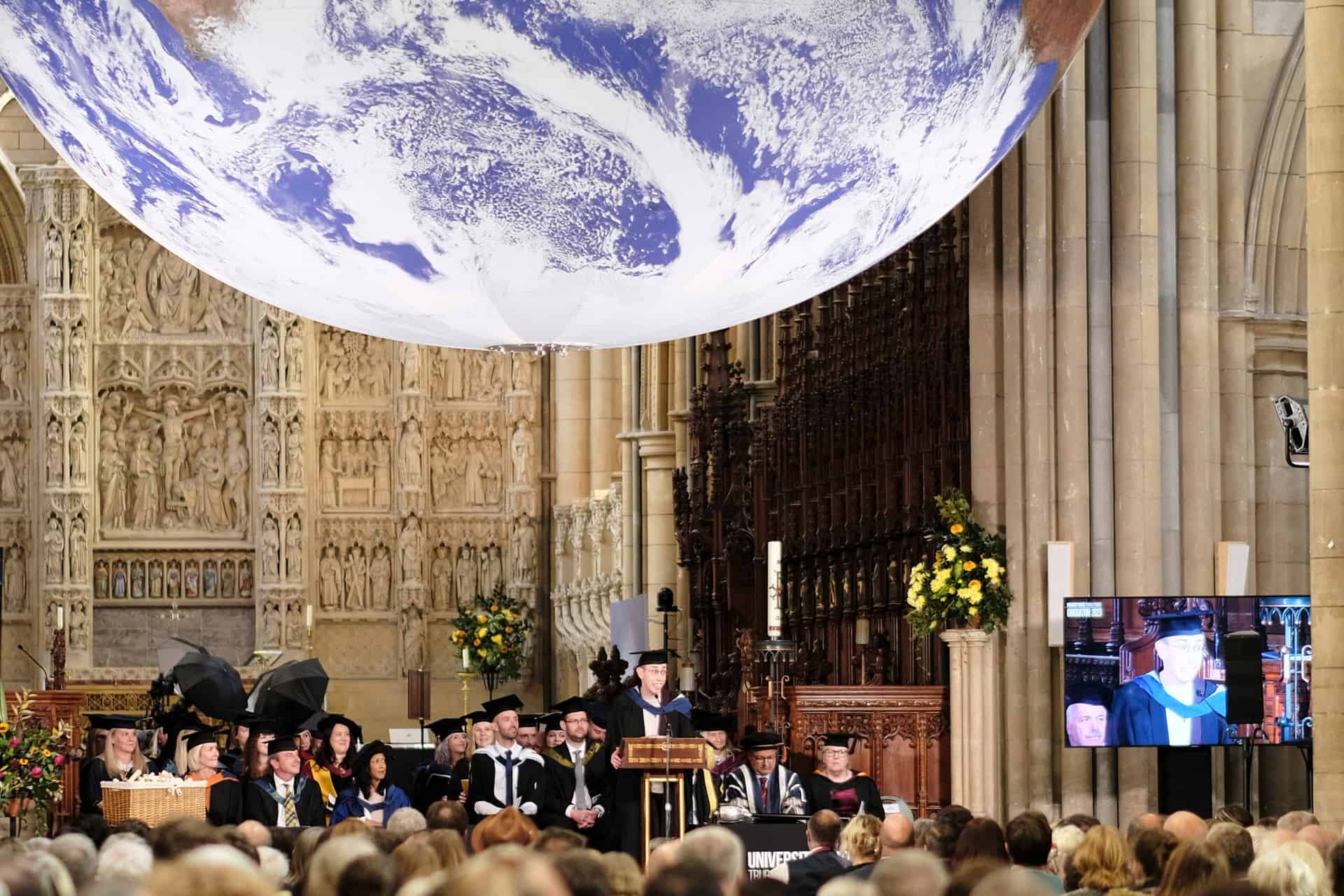 Cathedral 6 The University Centre Truro & Penwith Graduation 2023. An image of Roland Bray giving a speech on the stage.