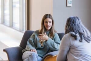 The young adult female talks to the counselor about relationship issues she is having.