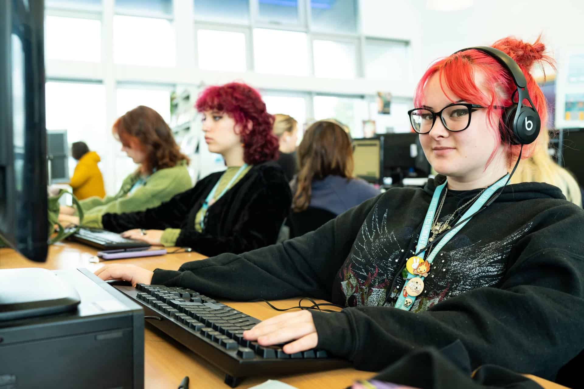 A person sits at a computer in Penwith Learning Centre.