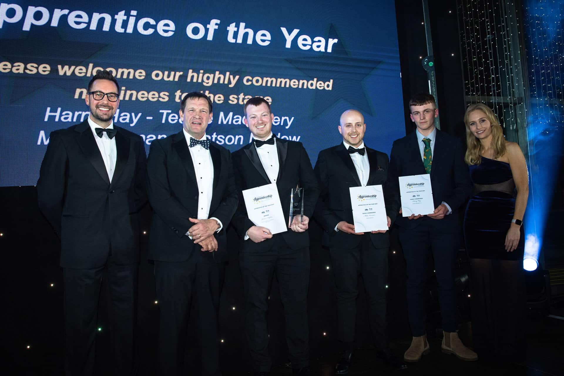 A group image from the Cornwall Apprenticeship Awards 2024. A group of winners and the night's hosts smile for the camera.