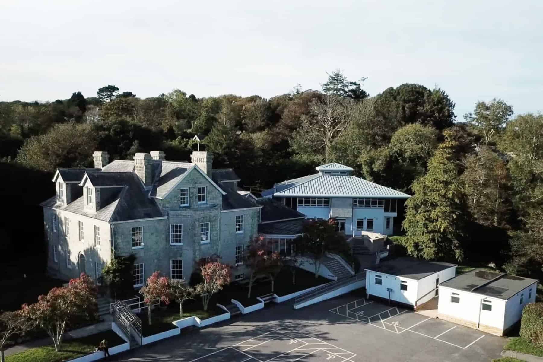 An aerial view of the Tregye campus including trees and the car park.