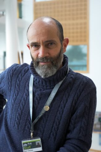 An image of Ben Delap, curriculum area lead at Truro College. Ben is wearing a blue jumper and looking at the camera.