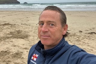 Charlie Morrow on the beach in an RNLI jacket.