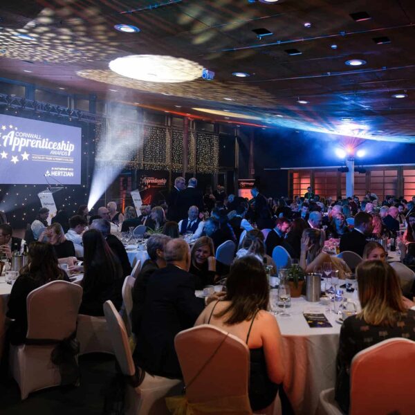 The event space at the Apprenticeship Awards. Guests sit at their round tables chatting.