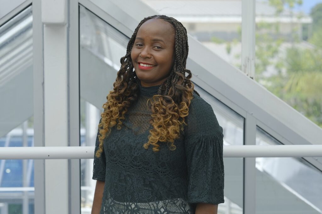 Babrah smiles down camera having emigrated from Uganda and successfully achieved her degree.