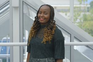 Babrah smiles down camera having emigrated from Uganda and successfully achieved her degree.