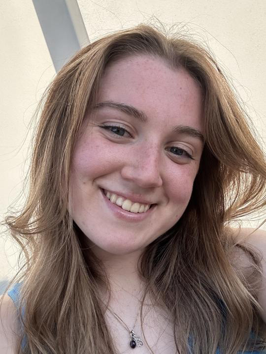 A portrait photo of Lauren Chessman. She has long hair and is smiling at the camera.