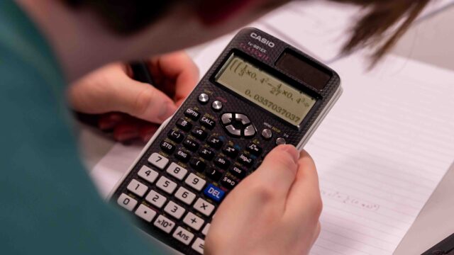 A close-up of a calculator with an equation on the screen.