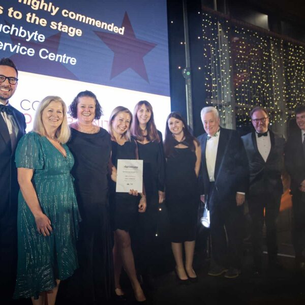 A group of guests from the Apprenticeship Awards gather on the stage.