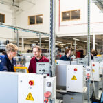 An image of the valency building at Truro and Penwith College. Students are using the engineering equipment with a member of staff present.