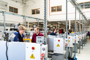 An image of the valency building at Truro and Penwith College. Students are using the engineering equipment with a member of staff present.