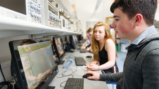 Students sat together at computers looking at data.