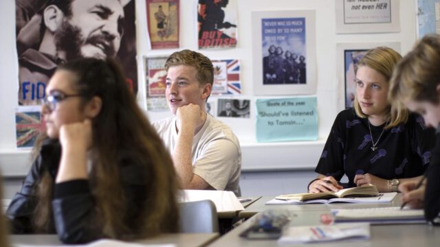 Students in a classroom looking towards the front.