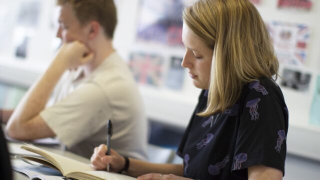 A student writing in a notebook.