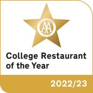 An award logo. The text reads 'College Restaurant of the Year 2022/23'. A gold star above the text has the words 'Hotel Services, since 1908' inside it.