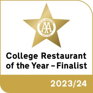 An award badge. The text reads 'College Restaurant of the Year - Finalist, 2023/24'. There is a gold star with text inside which reads 'Hotel Services, since 1908'.