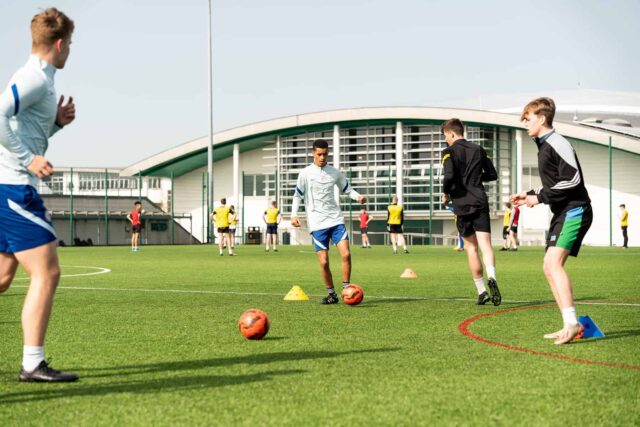 Students play football on the astro-turf.