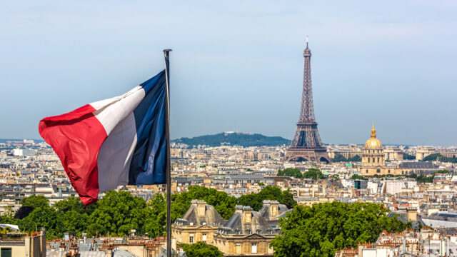 Skyline Paris with Eiffel Tower and French flag.